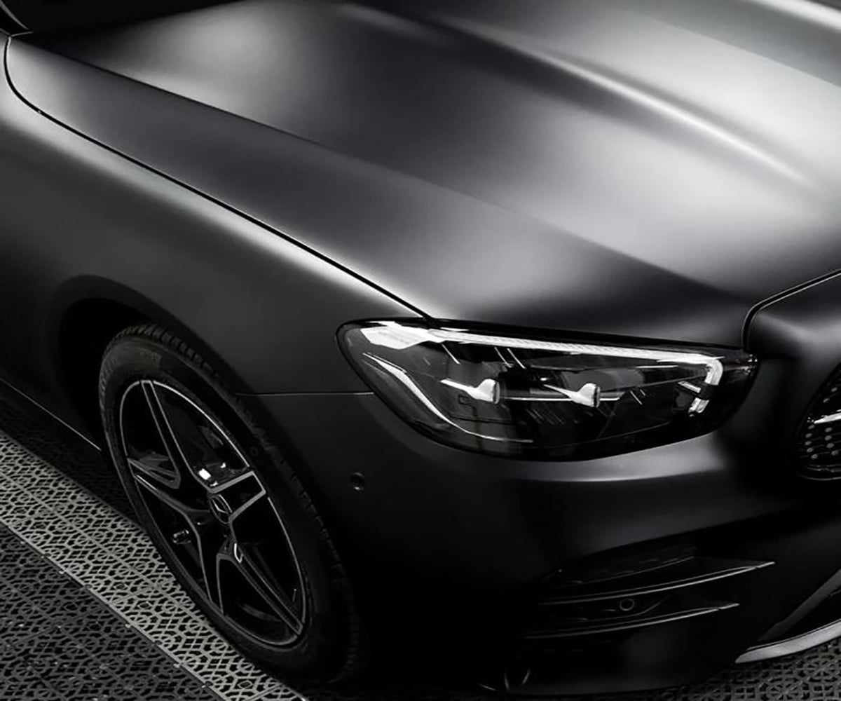 Ultra matte black vinyl wrap on aggressive performance coupe in Sydney sunlight