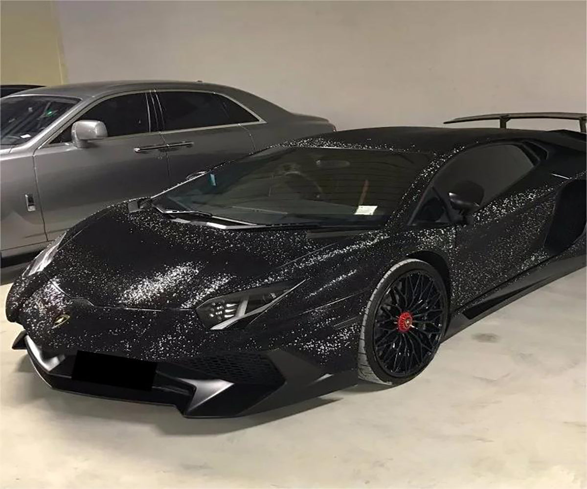 Matte glitter black car wrap on a luxury sports car showing sparkling light depth