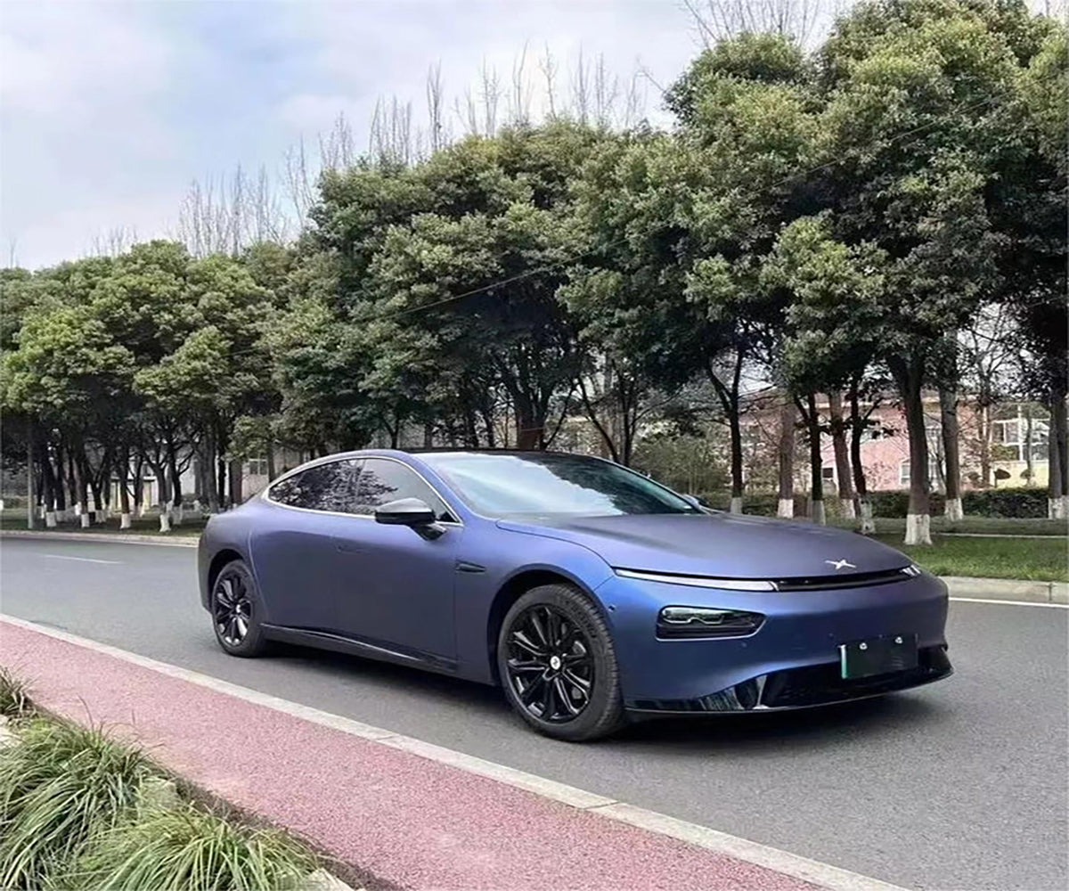 Satin dark blue wrap displaying midnight stealth tones and semi-gloss highlights on a performance sedan in Sydney