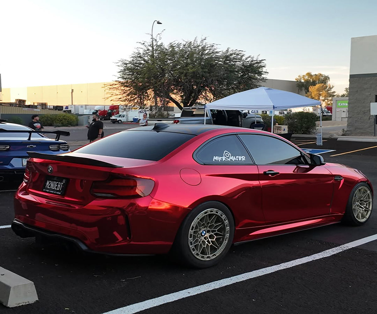 Candy apple red car wrap exhibiting dynamic liquid optical depth under direct Australian UV sunlight