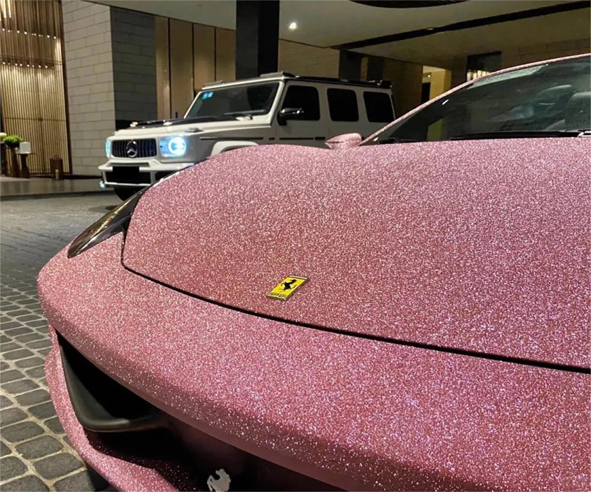 Matte glitter pink car wrap full body view under sunlight on a modern sedan