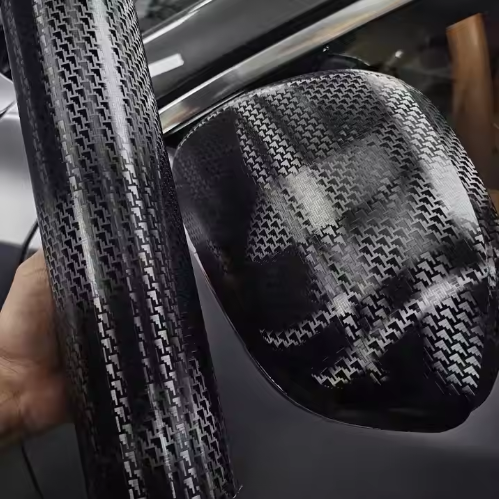 Macro closeup of Carbon Fiber Car Wrap showing 3D weave texture and elite Black Car Wrap seamless finish.