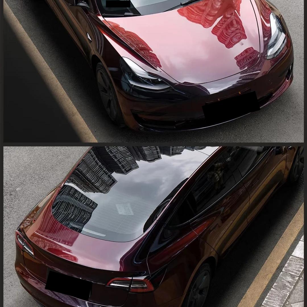 Side angle close-up showcasing the dramatic transition from a gloss black car wrap to a deep red car wrap.