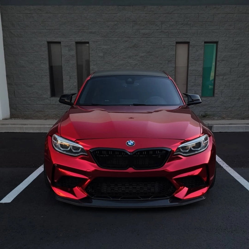 Stunning gloss candy apple red car vinyl wrap PET texture on car hood, showcasing rich multi-layer deep red metallic luster.
