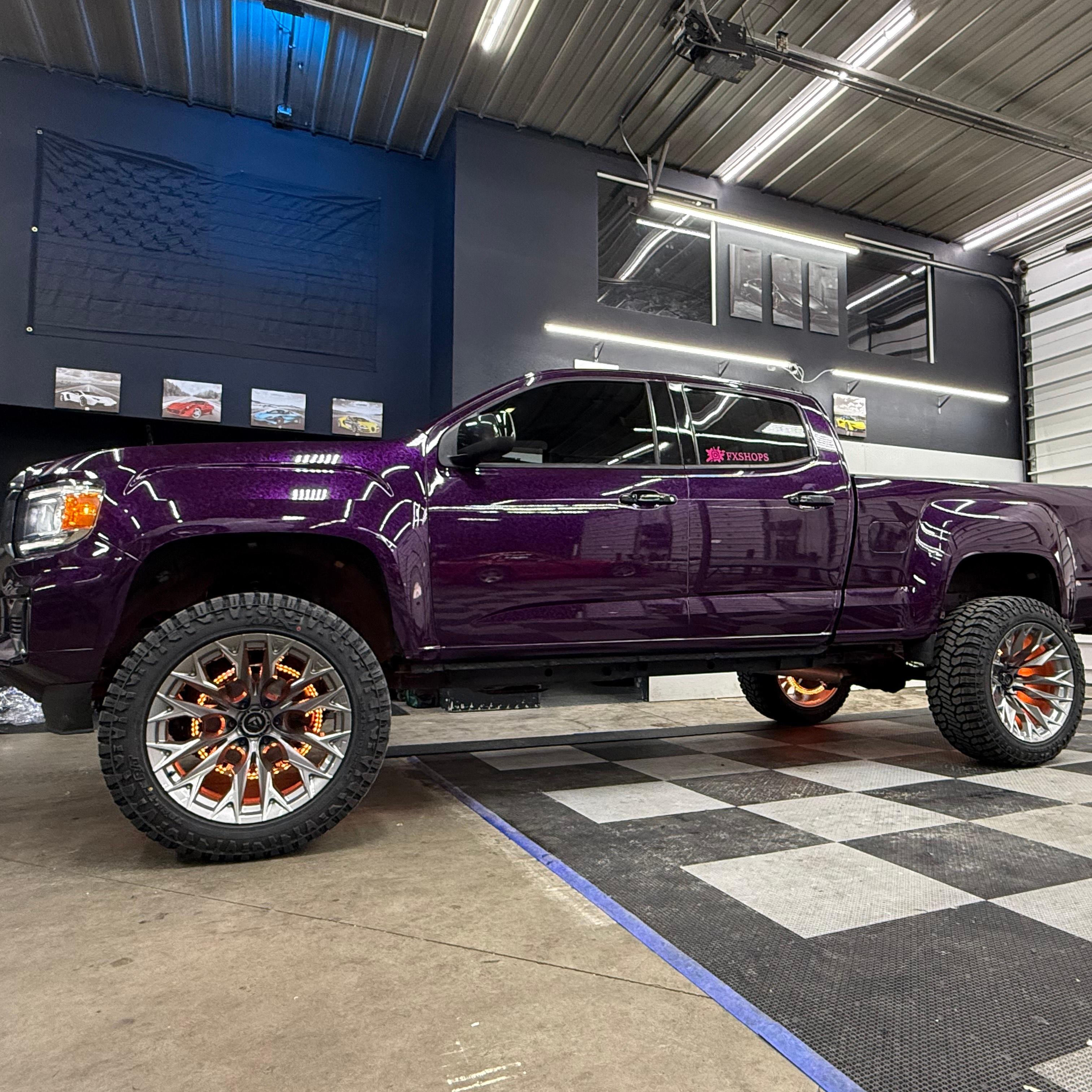 Modified track vehicle showcasing an aggressive hood overhaul finished in exotic Purple Car Wrap composite.