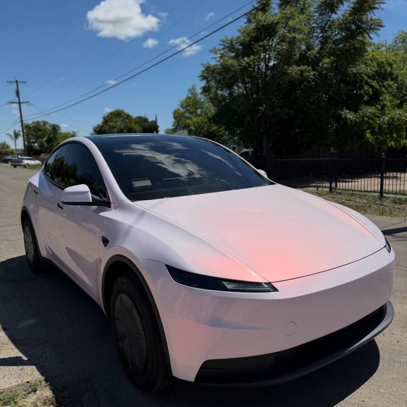 Luxury SUV wrapped in pollen pink white car vinyl, displaying stunning pearlescent gloss pink vinyl wrap shift on body lines.