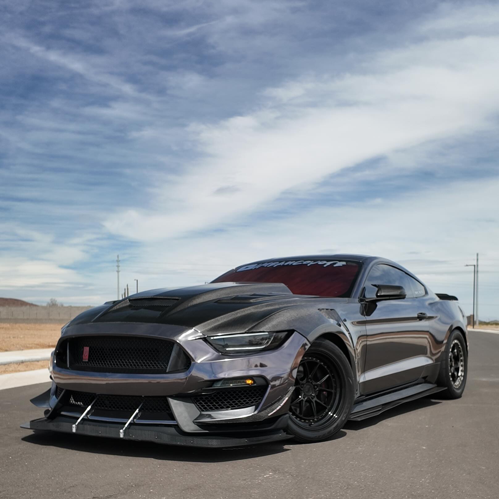 ALUKOCARWRAP liquid mirror chrome car wrap in gloss black, displaying a high-definition reflective styling transformation.