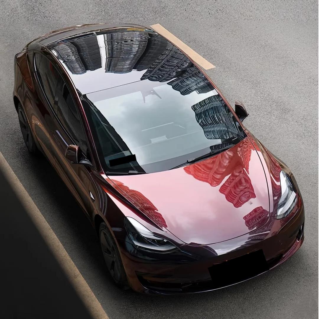 Full body makeover featuring ALUKOCARWRAP Gloss Chameleon Black Red Color Shift Car Wrap under natural daylight.