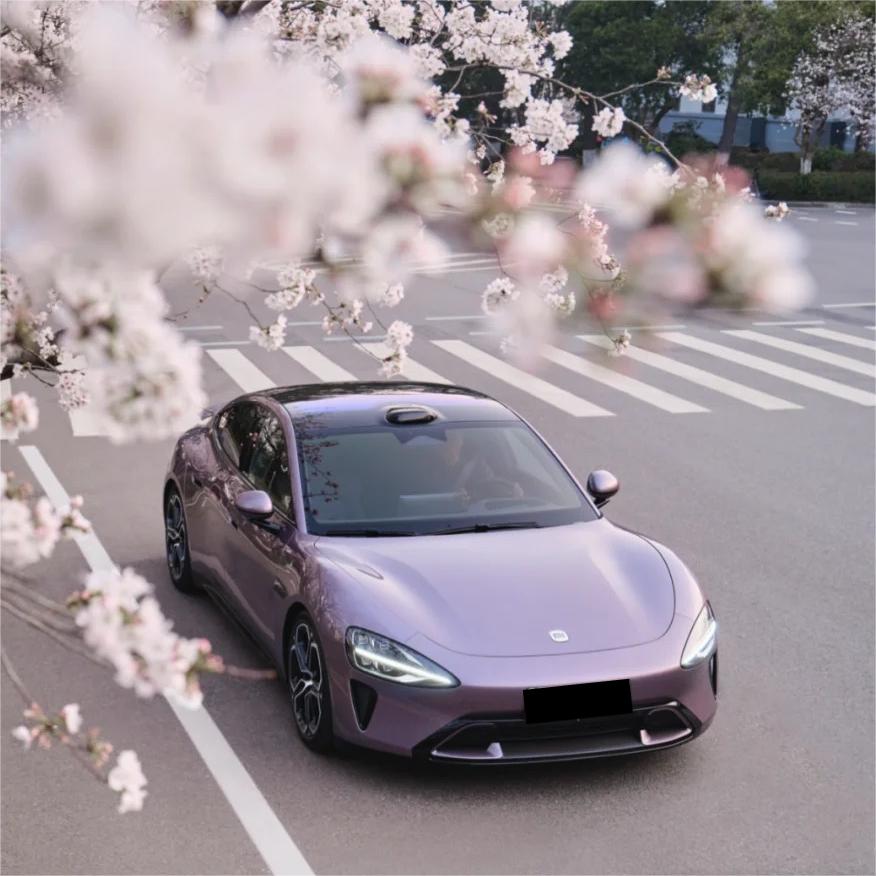 A modified sports car in motion wrapped in ALUKOCARWRAP sunshine purple car wrap, capturing the brilliant crystal reflection.