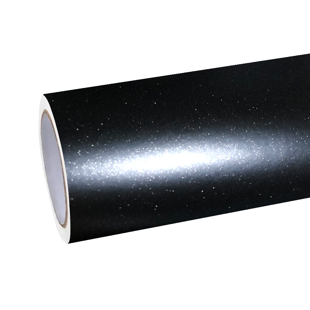 Studio macro shot of ALUKOCARWRAP matte metallic car wrap material, capturing the flawless zero-glare texture of volcanic obsidian pigments.