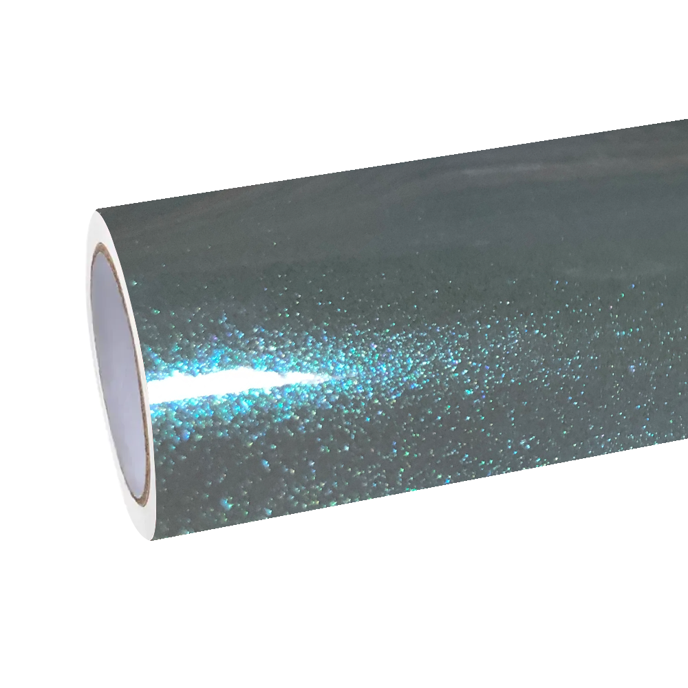 Blinding workshop spotlights reflecting off the molten-glass finish of ALUKOCARWRAP grey blue car wrap film to highlight its suspended metallic diamond flakes.