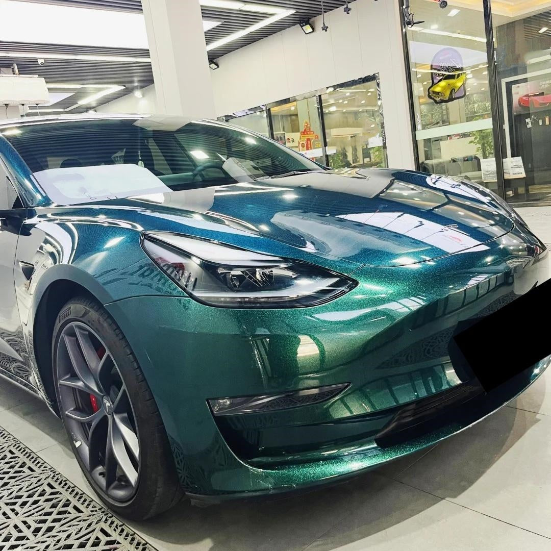 Exotic supercar showcasing the ALUKOCARWRAP Gloss Metallic Diamond Emerald Green Car Vinyl Wrap, radiating a deep alchemical liquid emerald depth under gloomy ambient light.