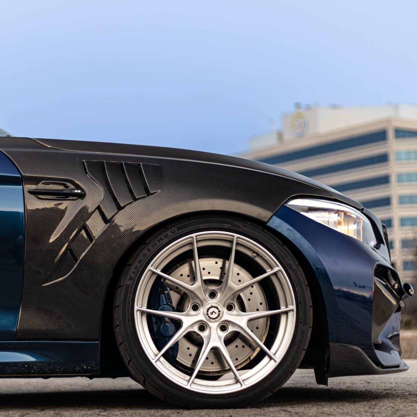 Close-up of premium emulational black car wrap showing deep 3D optical illusion and smooth PET high gloss finish.