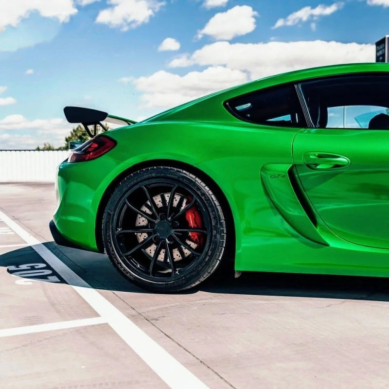 Close-up of premium metallic flame green car vinyl wrap PET texture, highlighting the deep gloss finish and metallic flakes.