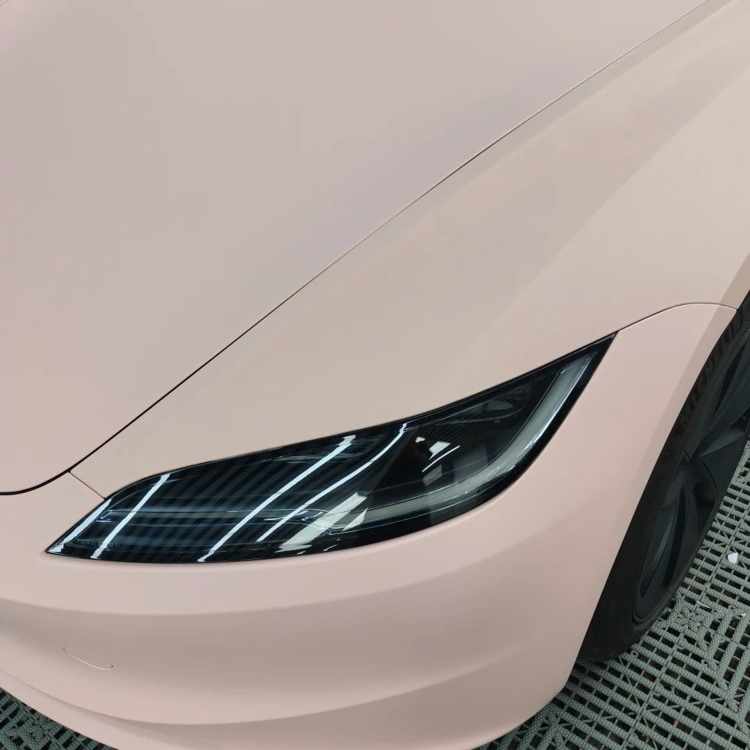 Close-up detail of the Ultimate Flat Baby Pink Car Wrap PET on an automotive fender, showing the zero-reflection velvety texture.
