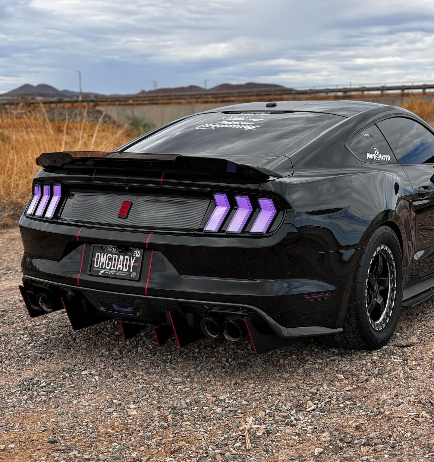 Super glossy black car wrap with zero orange peel effect, featuring ALUKOCARWRAP mirror chrome finish and durable PET backing.