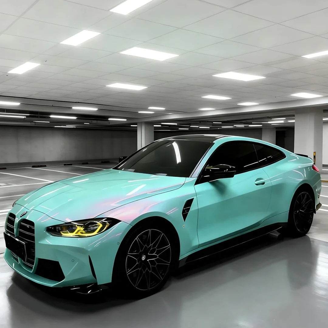 Luxury sports car covered in a unique tiffany rose car wrap gleaming with an icy gloss blue undertone under studio lights.