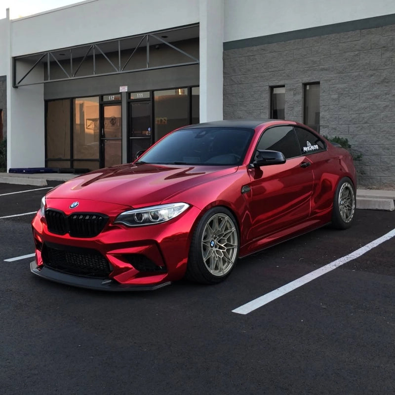Exotic supercar wrapped in Aluko gloss chrome candy apple red car vinyl wrap PET, exhibiting a flawless mirror reflection.