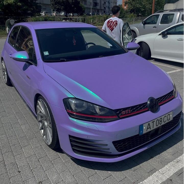 A wide vehicle hood protected by ALUKOCARWRAP Gloss Chameleon Car Wrap under direct sunlight, reflecting a high-saturation gloss metallic dual-tone surface.