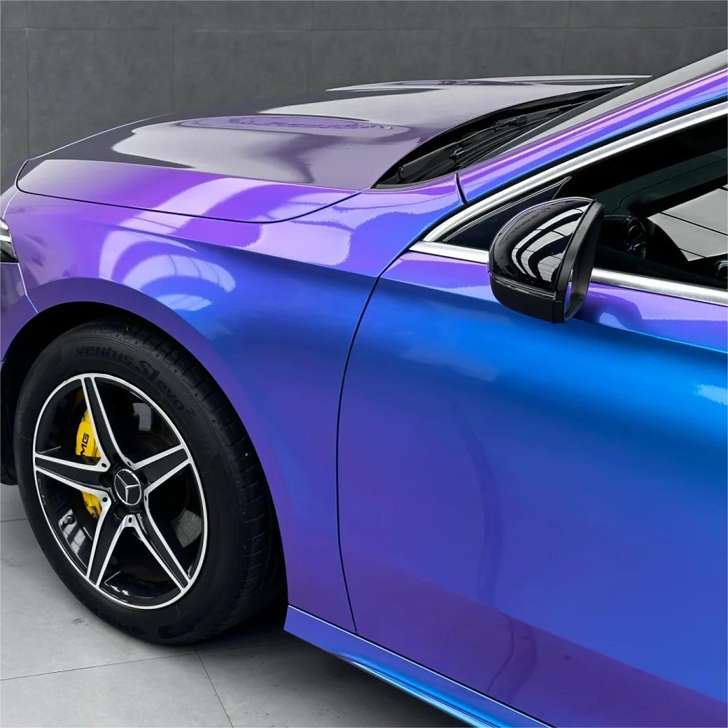 Side view of a vehicle featuring blue purple car wrap with a high-definition gloss chameleon finish.