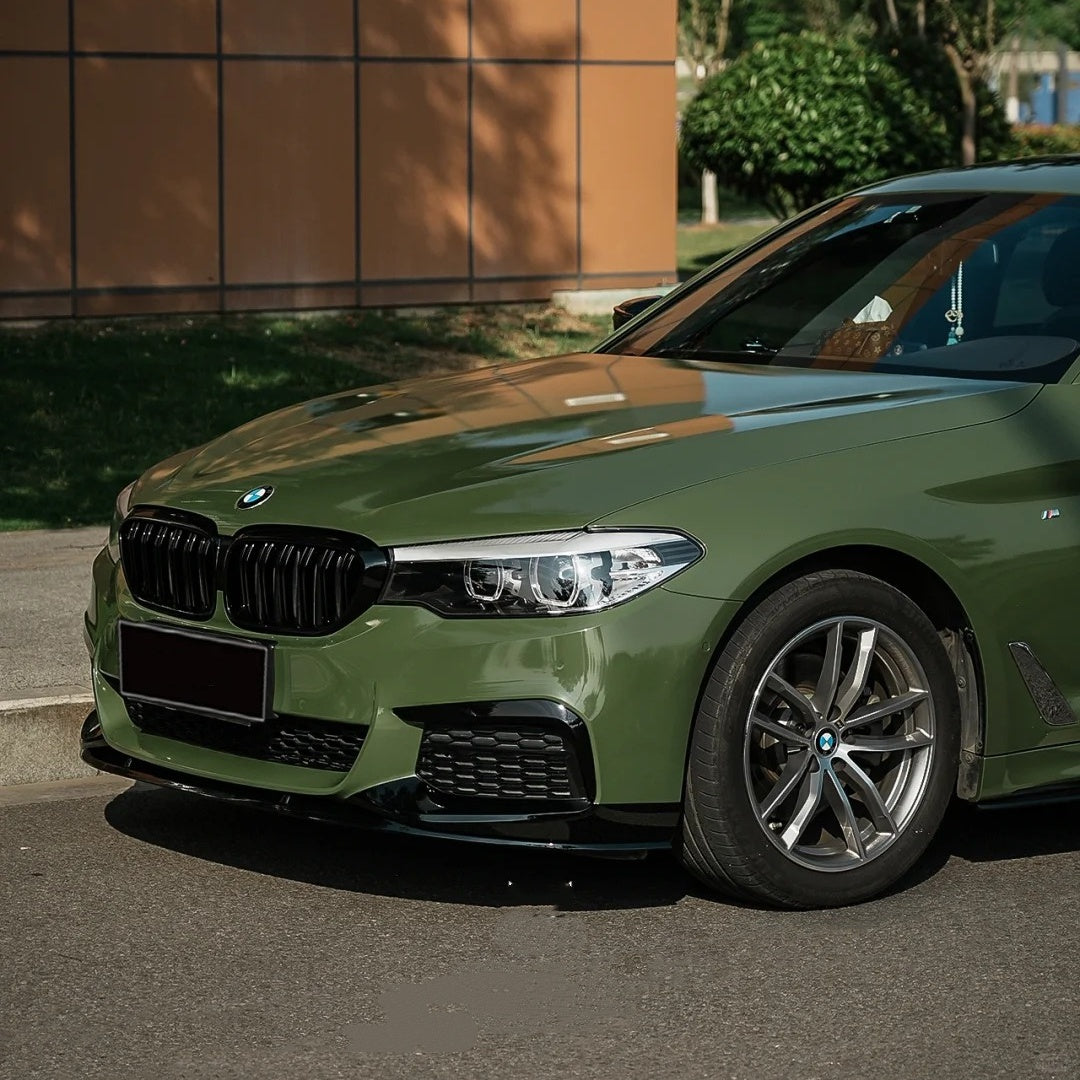 Detailed macro photography of vehicle hood lines utilizing ALUKOCARWRAP Crystal Green Car Wrap, featuring a perfect mirror-smooth Green Car Wrap sheen.
