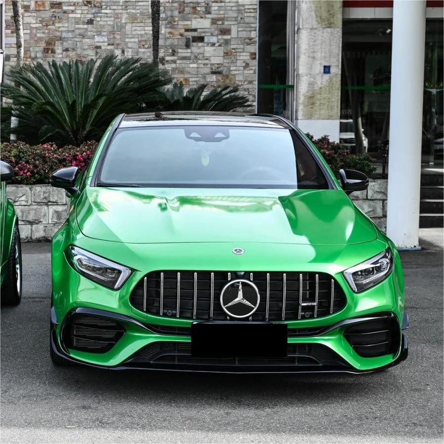 Deep body lines capturing a flawless application of ALUKOCARWRAP gloss metallic car wrap film, magnifying a sun-drenched green car wrap saturation.
