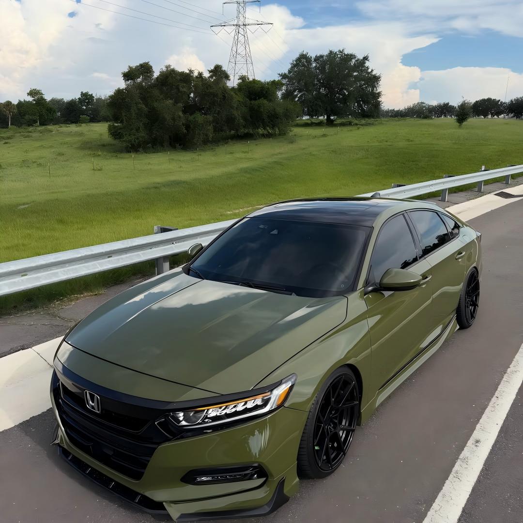 Front bumper close-up of ALUKOCARWRAP Gloss Military Green Car Vinyl Wrap PET demonstrating deep tactical color depth