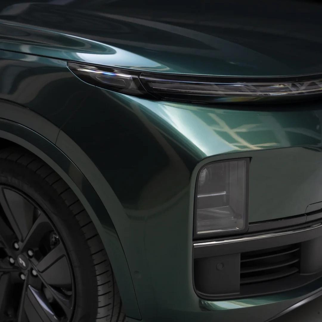 Close-up of Gloss Metallic Ideal Dark Green Car Vinyl Wrap by ALUKOCARWRAP, showcasing brilliant metallic micro-flakes.