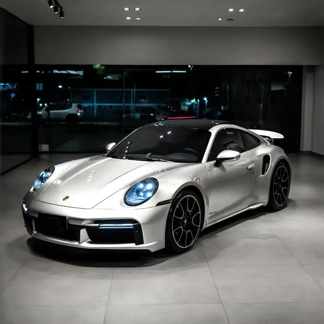 An exotic sports coupe fully transformed with ALUKOCARWRAP Victor Silver Car Wrap, exhibiting a liquid-mercury mirror surface under open bright daylight.