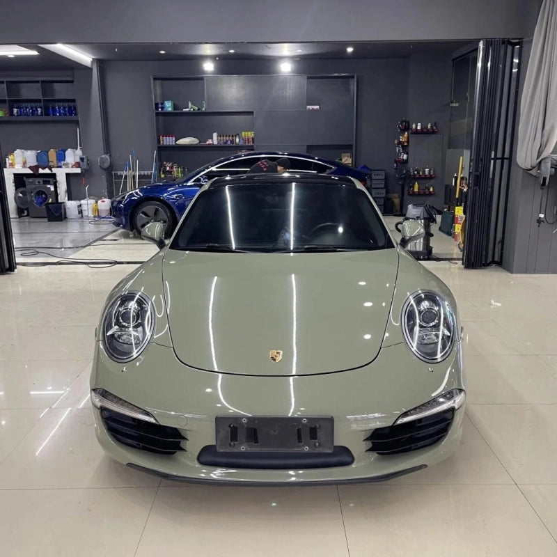 Detailed view of super glossy Khaki Green car vinyl wrap PET film, capturing the intense paint-like depth under dynamic lighting.