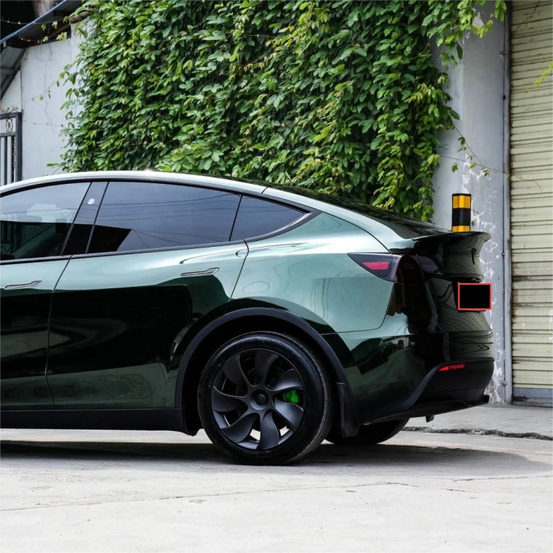 Close-up of glossy paint metallic Midnight Green car vinyl wrap PET, highlighting the deep dark-to-green metallic flake travel.