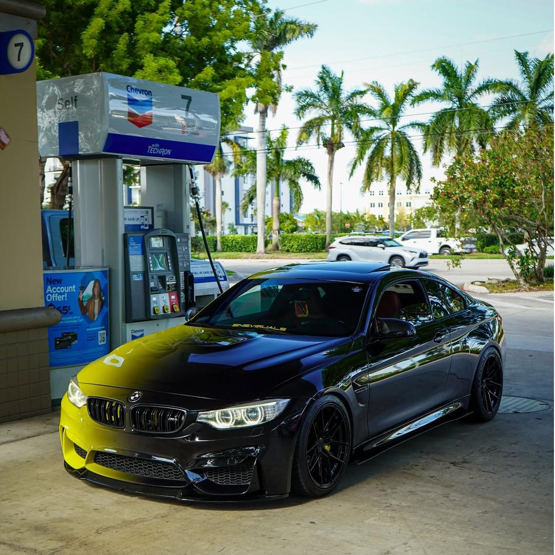 A custom sports car in ALUKOVINYL Black To Green Gradient Custom Vinyl Wrap, showing a seamless dark to liquid green fade.