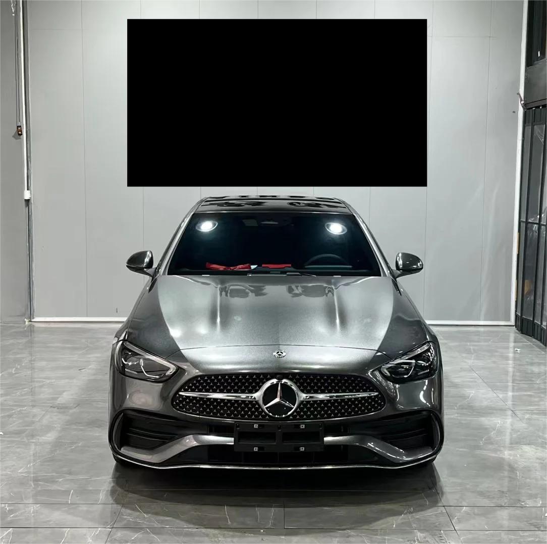 Graphite grey car wrap simulating liquid steel finish applied to sports car quarter panel and aerodynamic contours.