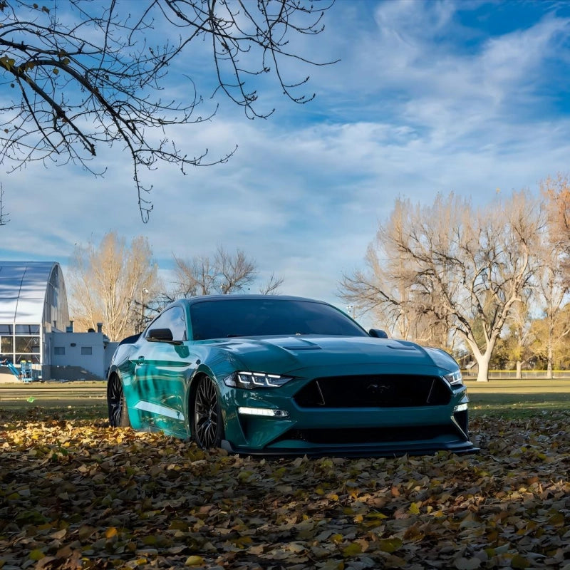 Hyper-hatchback completely transformed with Aluko gloss Storm Green car vinyl wrap PET, showing a sleek ceramic-like gloss reflection.