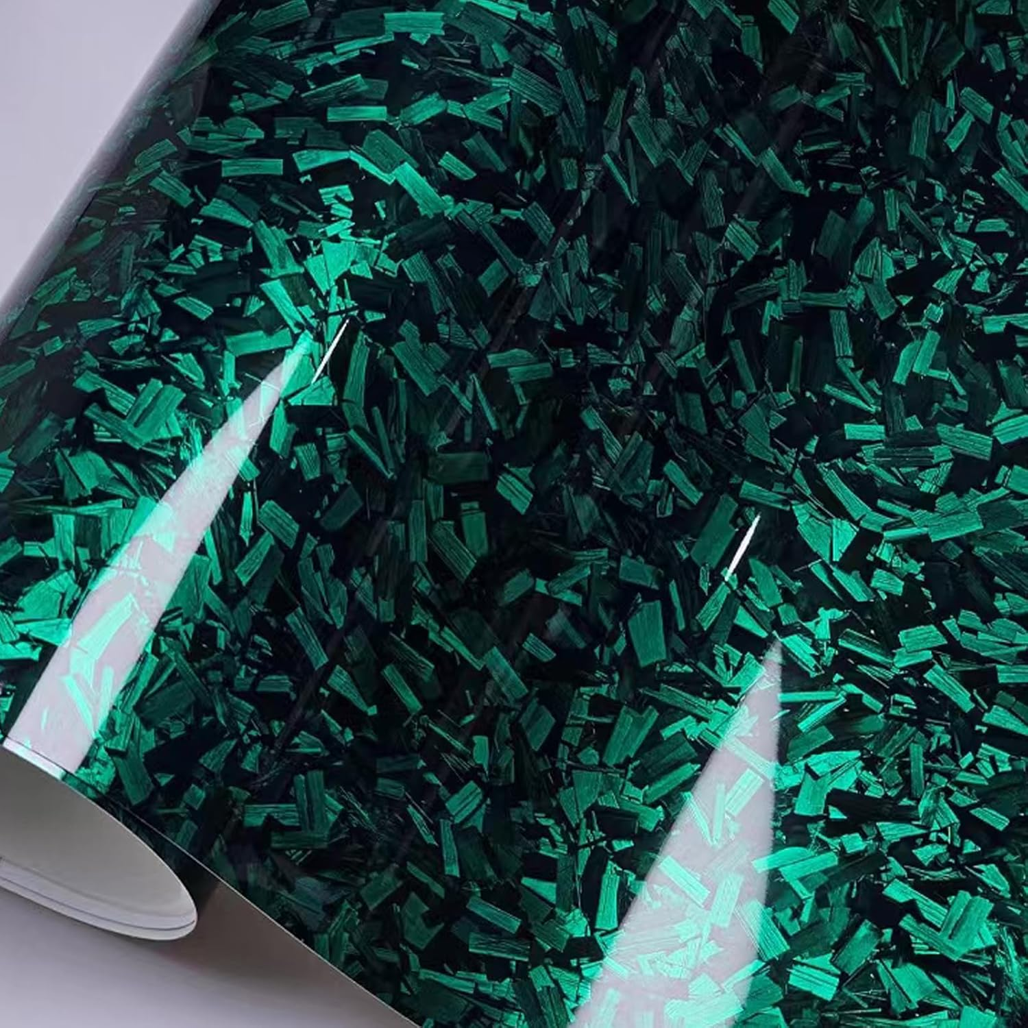 Close-up of marbled green forged car wrap texture with protective PET backing, premium gloss car wrap styling.
