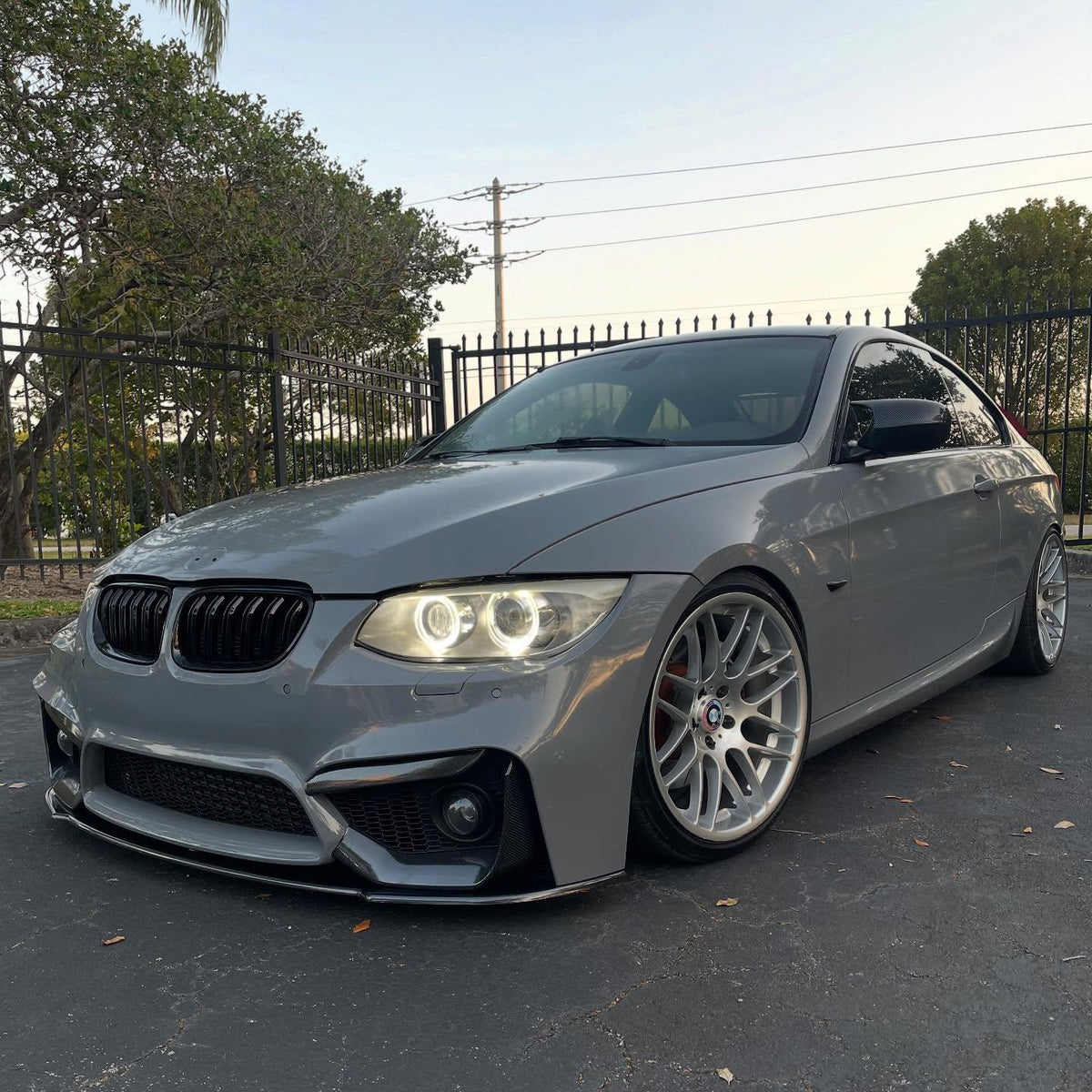 High-angle view of a customized vehicle completely wrapped in ALUKOCARWRAP Gloss Nardo Grey Car Vinyl Wrap PET, displaying sleek OEM lines.
