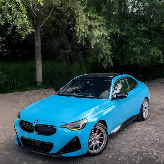 ALUKOCARWRAP Gloss Light Sky Blue Car Vinyl Wrap PET installed on sports car bumper under bright sunlight