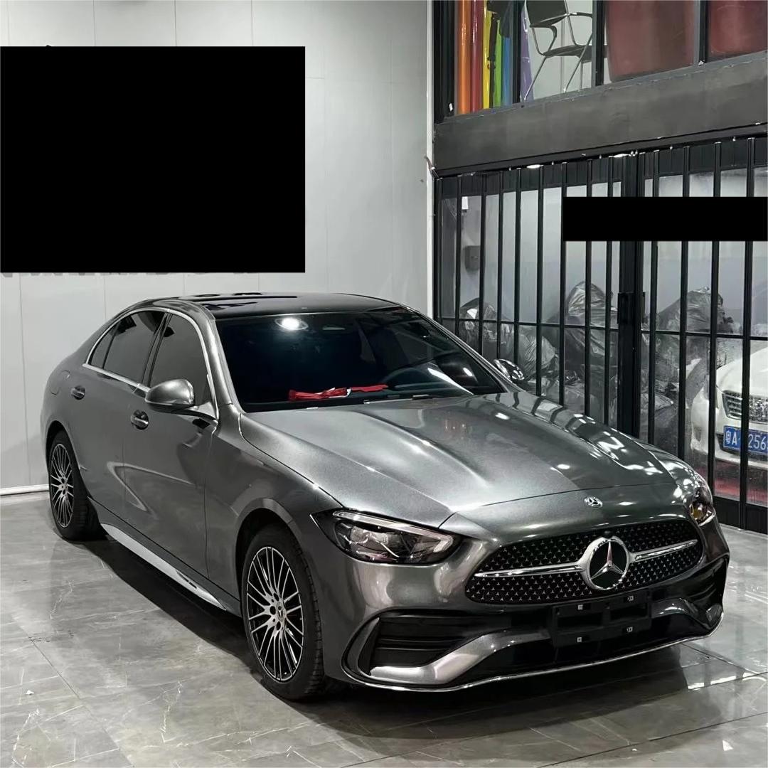 Light grey car wrap vinyl film tension test showing low tack air release liner conformability during workshop wrapping.