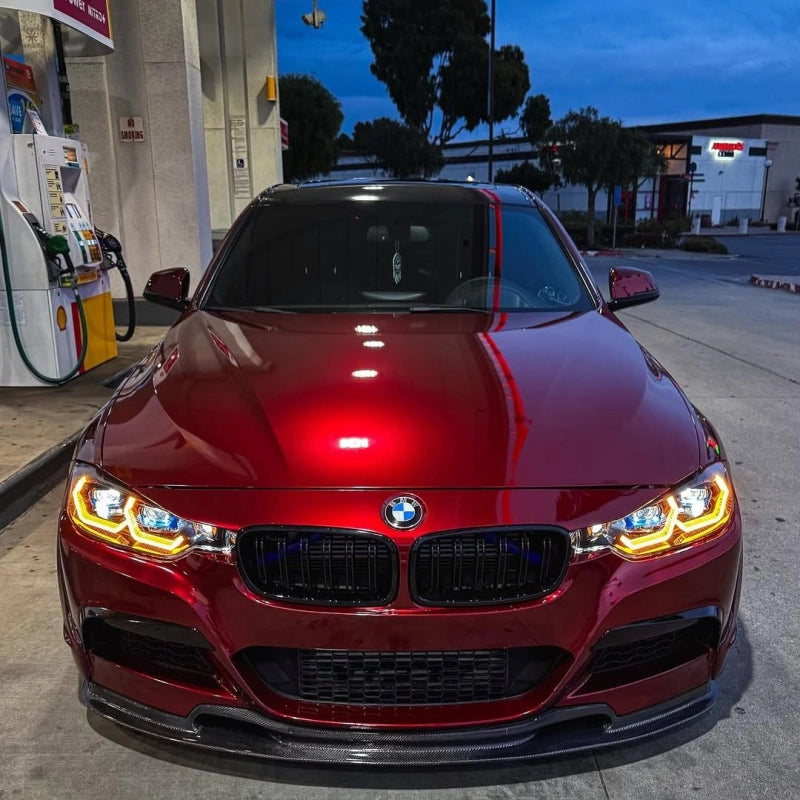 Close-up of liquid dragon red gloss car wrap PET on sports car, showcasing mirror-like ultra glossy surface and sharp reflections.
