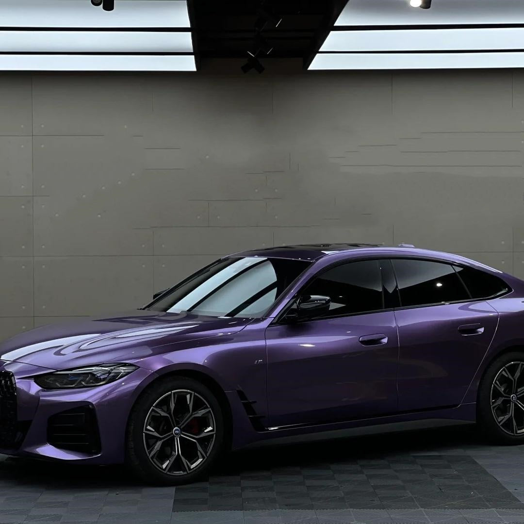 Exotic luxury sedan fully covered in purple car wrap, displaying the dynamic shifting tones of ALUKOCARWRAP russet purple car wrap.