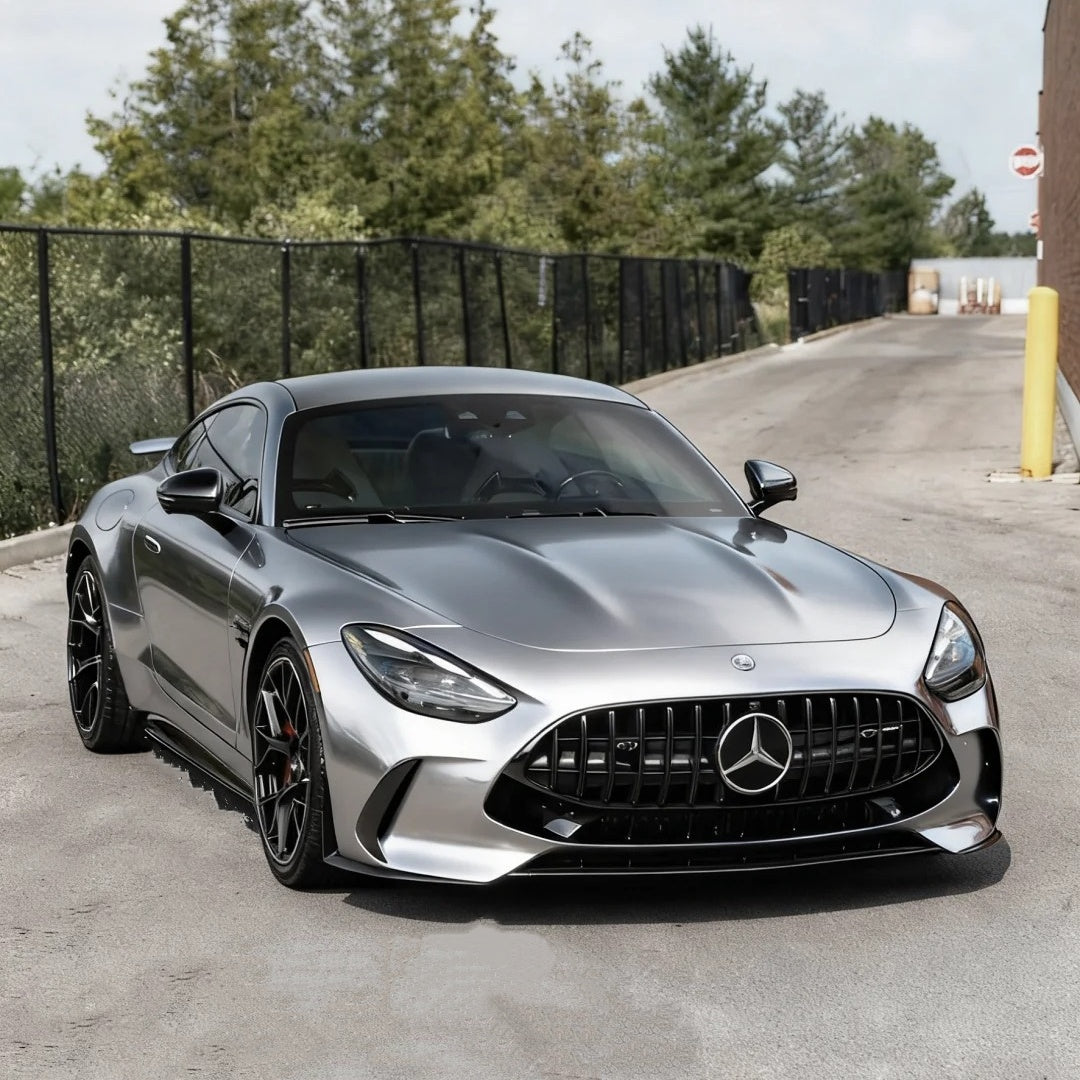 Supercar sculpted with ALUKOCARWRAP Aluminum Silver Car Wrap, reflecting dramatic light and shadows with an authentic liquid metal finish.