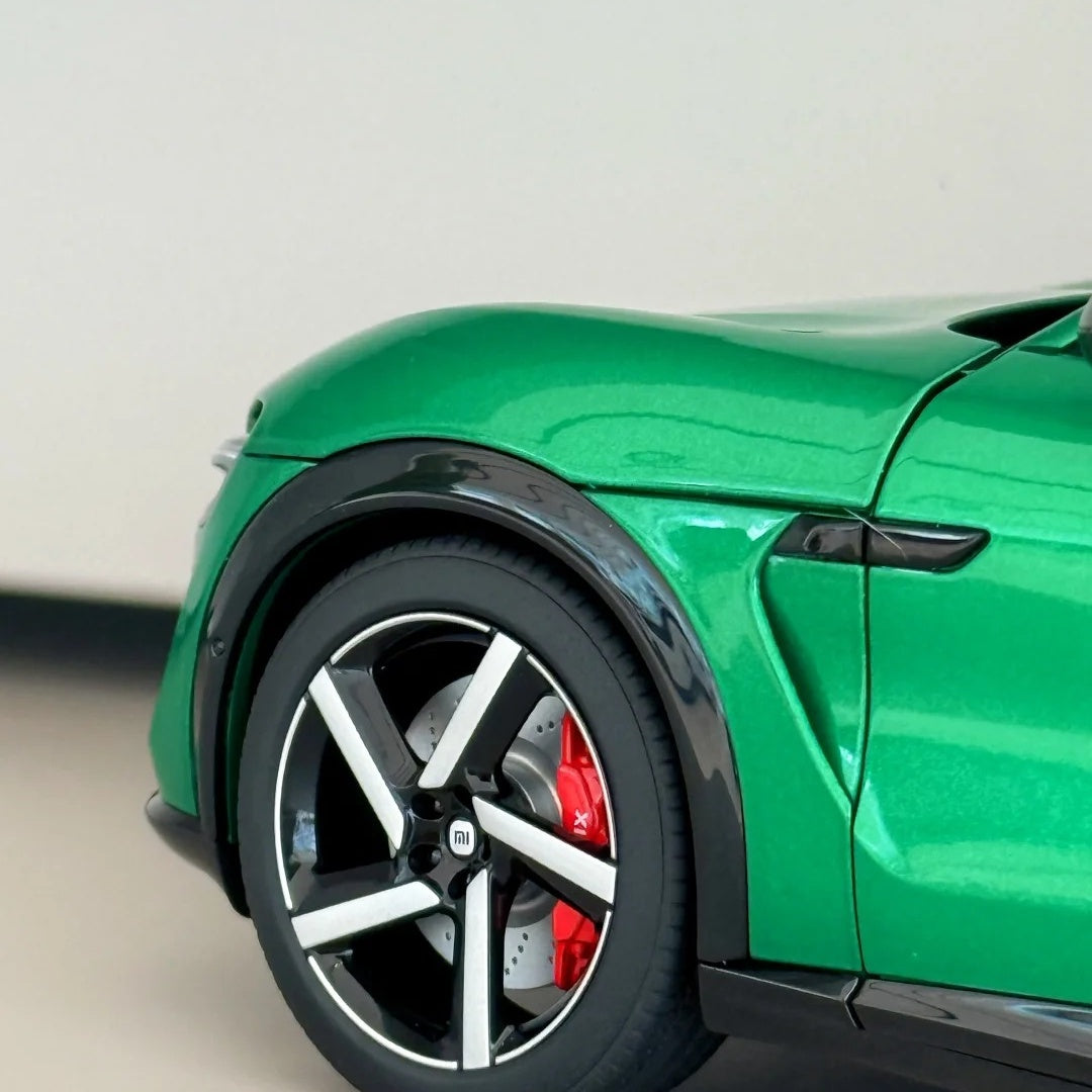 Sunlight reflecting on MIUI green car wrap with gloss metallic finish, highlighting the deep emerald tones.