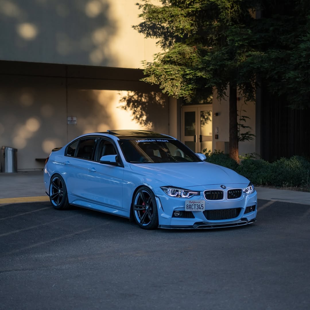 Dynamic outdoor perspective of ALUKOCARWRAP Gloss Light Sky Blue Car Vinyl Wrap PET under natural afternoon sunlight
