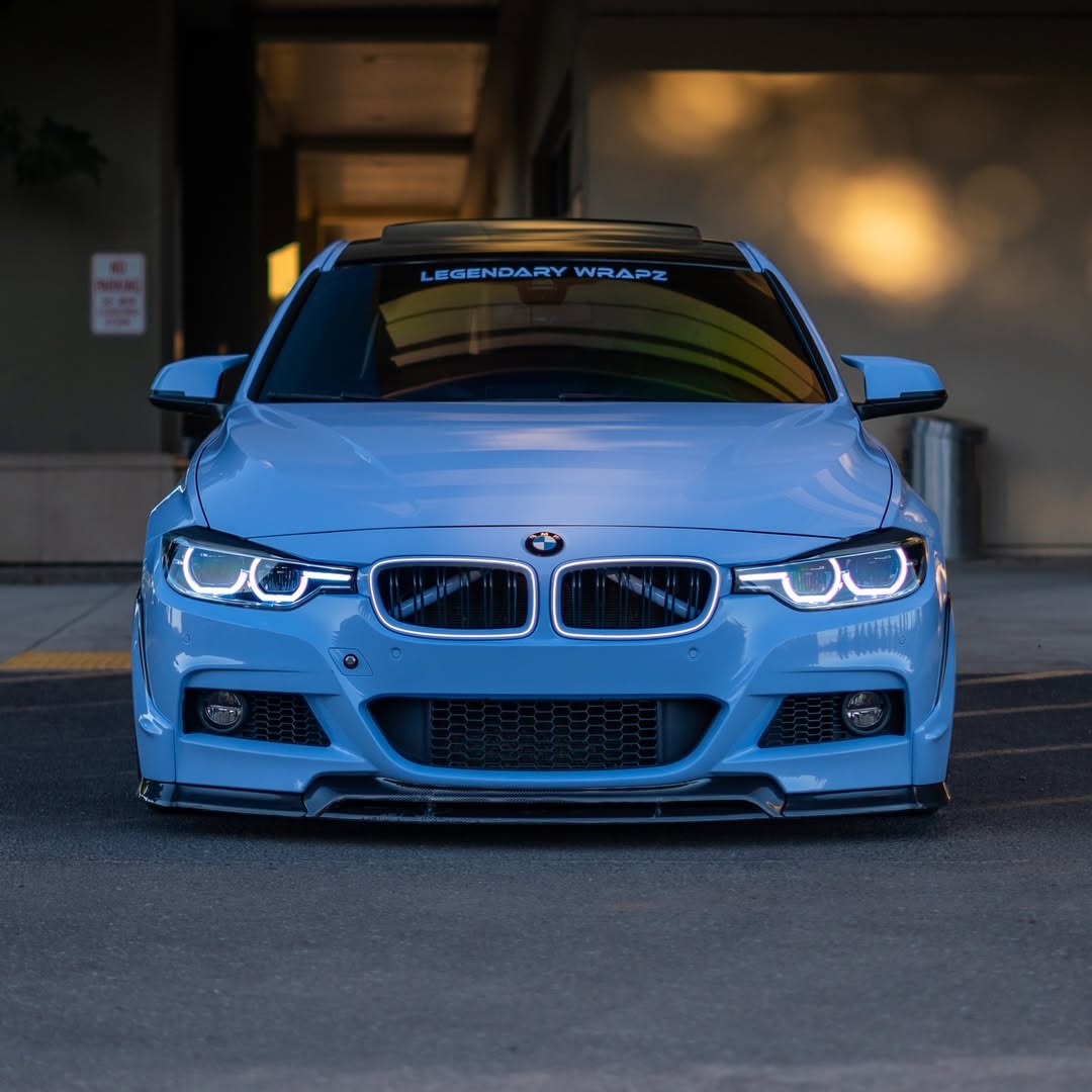 Professional installation of ALUKOCARWRAP Gloss Light Sky Blue Car Vinyl Wrap PET on a luxury coupe wheel arch