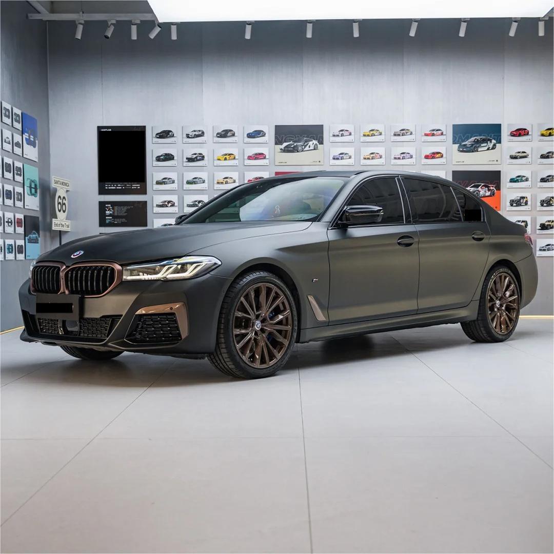 A luxury performance vehicle displaying non-reflective obsidian shadows and rich gold-dusted body creases in ALUKOCARWRAP matte metallic car wrap.