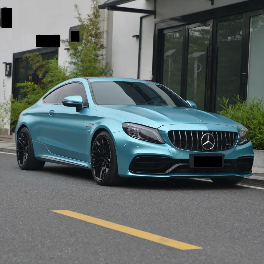Deep overcast daylight reflecting on sharp rear quarter panels styled with ALUKOCARWRAP matte metallic blue car wrap, revealing zero sun glare.