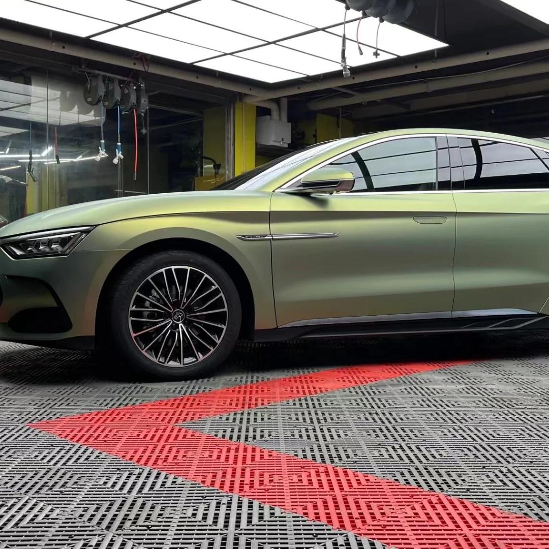 Side profile angle of a car body contour wrapped with ALUKOCARWRAP Bamboo Green Car Wrap, highlighting how the matte finish absorbs light to define deep body lines.