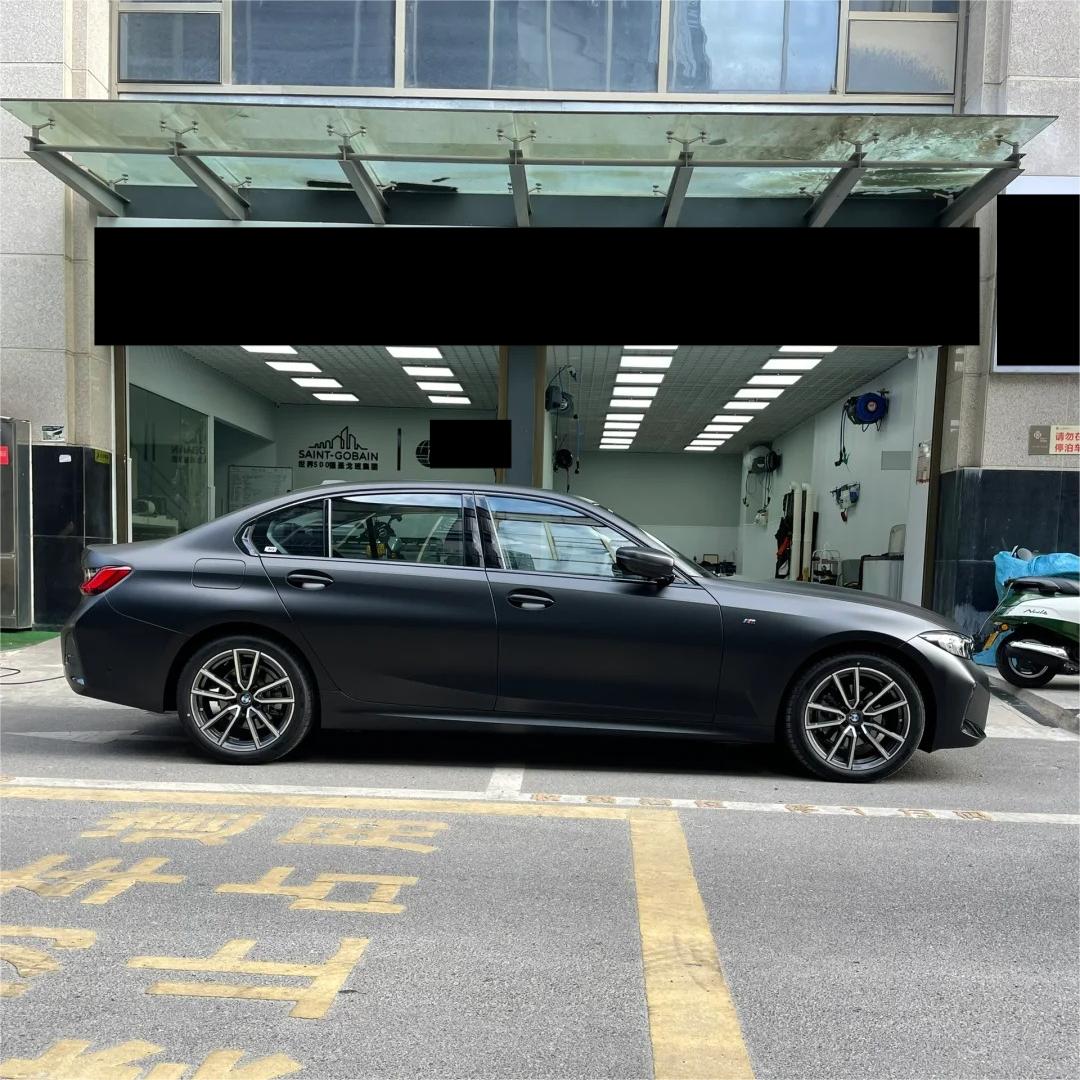 A menacing, radar-evading tactical stance on a supercar enveloped in ALUKOCARWRAP matte black car wrap with premium PET glossless uniformity.