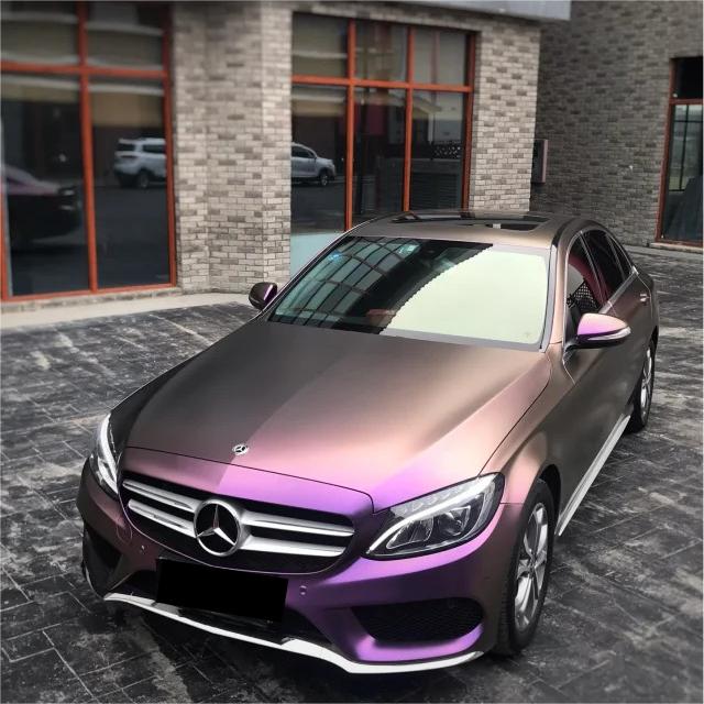 A radical, daylight-bending stance on a sports coupe wrapped in ALUKOCARWRAP metallic chameleon car wrap, displaying millions of embedded matte diamond car wrap flakes.