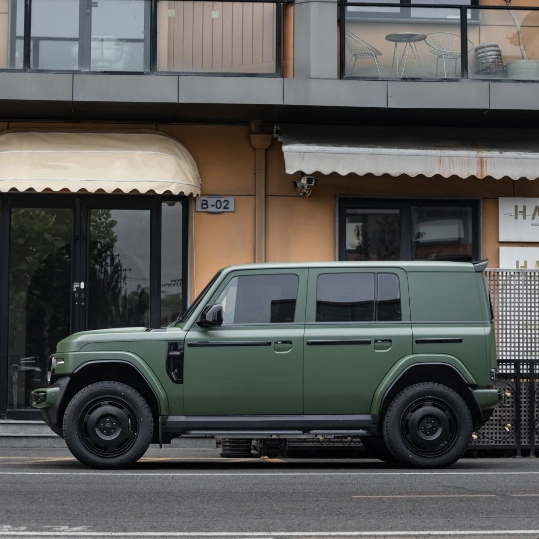 Full vehicle wrap effect of Ultimate Flat Army Green vinyl on a rugged SUV, showcasing a tactical matte green style.